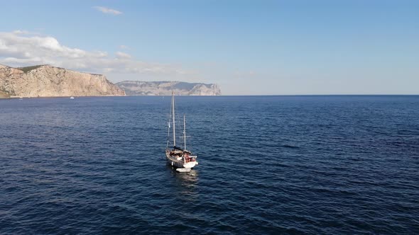 Aerial View Daytime Panoramic Scenic View of Drifting Sailing Yacht on Water Bay Surrounded By alt