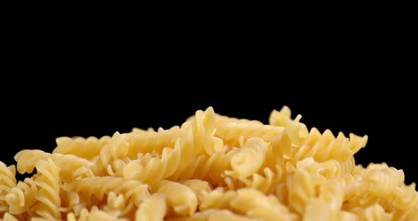 The Pasta Dry Fusilli Falls in a Heap on the Table. alt