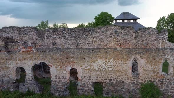 Medieval Castle Ruins in Latvia Rauna. Aerial View Over Old Stoune Brick Wall of Raunas Castle  alt