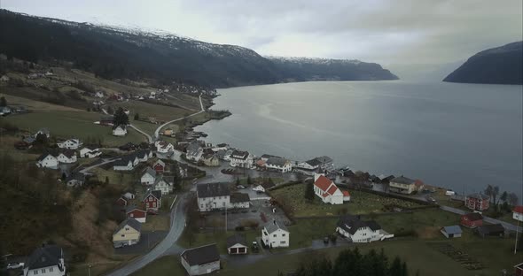 Aerial shot of Utvik village located on shore of Norwegian fjord alt