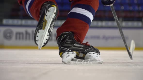 Ice Hockey. The Hockey Player Does the Accelerates on the Ice Before Camera in Slow Motion