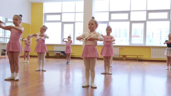 Group of little girls practicing in ballet school