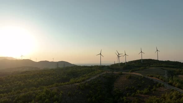 Wind Turbines Spinning At Sunset