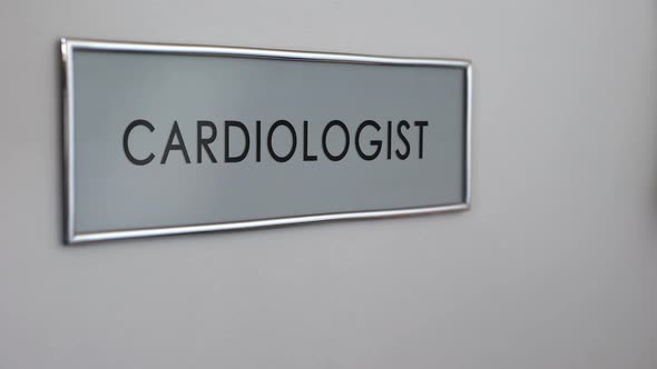 Cardiologist Room Door in Hospital, Patient Hand Knocking Closeup, Heart Disease alt