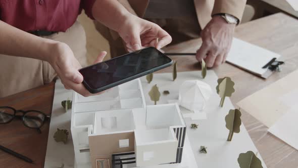 Architects Taking Top-View Shot Of 3D House Model alt