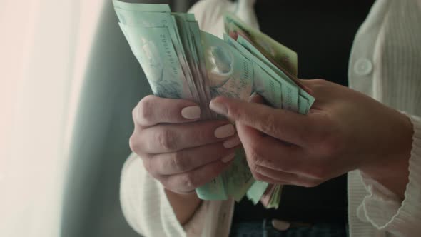 Women's Hands Make a Fan of Money the Girl Counts Vietnamese Dongs or Cash at Home alt