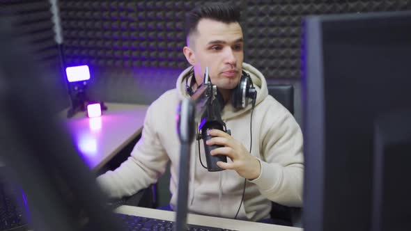 An Agitated Radio DJ is Preparing to Conduct a Live Broadcast in a Radio Studio alt