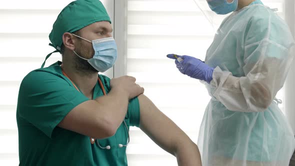 Nurse Administers a COVID19 Vaccine to Doctor alt