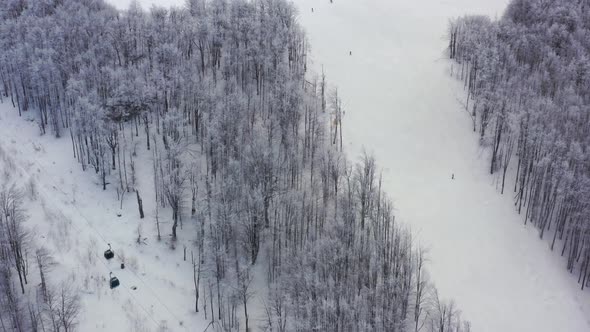 Aerial view at the ski slopes on a sunny winter day