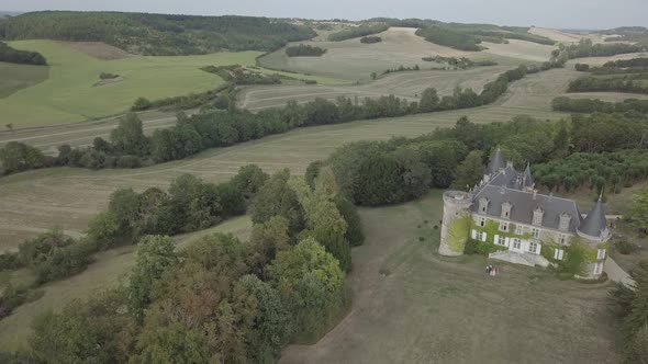 Aerial view of french castle Chateau de La Cote Rural summer landscape green meadows fields trees 
