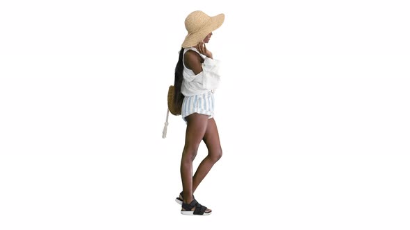 Smiling Young African American Woman in a Straw Hat Posing on White Background
