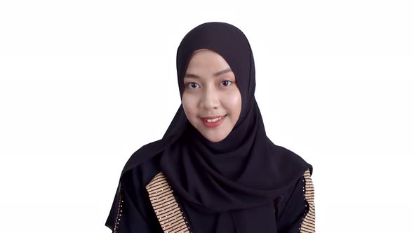Portrait Young Muslim woman wearing traditional clothing and hijab toothy