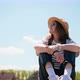 A Young Woman in a Hat and Glasses Sitting and Enjoying Fresh Air - VideoHive Item for Sale