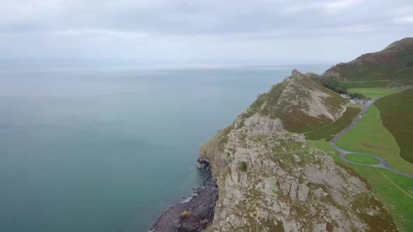 Aerial tracking forward over the Valley of Rocks and Wringcliff Bay in Devon. Stunning rocky crags a alt