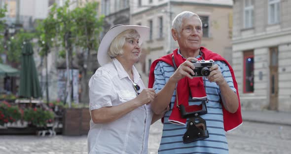 Senior Male and Female Tourists Makes a Photo While Traveling in Lviv, Ukraine alt