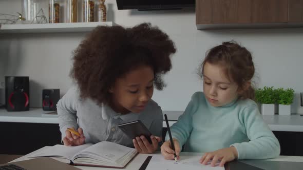 Positive Cute Preadolescent Multiethnic Girls Doing Homework Together ...