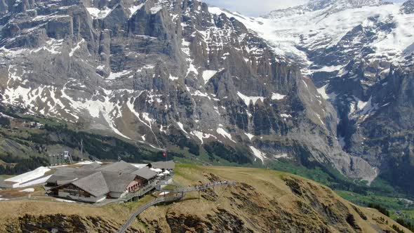 Drone shot of the First mountain over Grindelwald town, Switzerland alt
