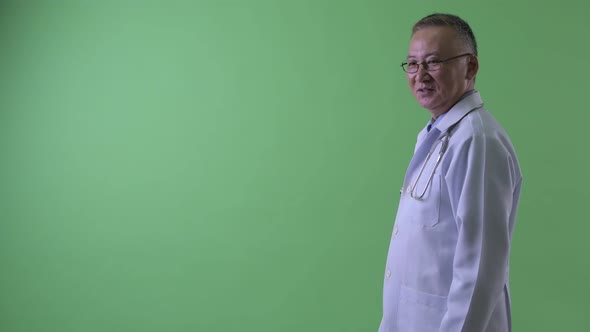 Profile View of Happy Mature Japanese Man Doctor Smiling alt