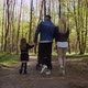 Family With Small Child In Stroller Walks In An Park. - VideoHive Item for Sale