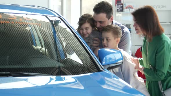 Mother Father and Child Buying Car at Dealership a New Family Auto alt