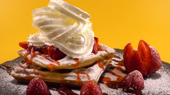 Belgian waffles with strawberry, sweet strawberry topping, whipped cream and powdered sugar alt