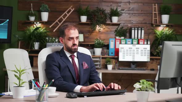 Zoom in Shot of Businessman Working Alone in Office with Modern Design alt