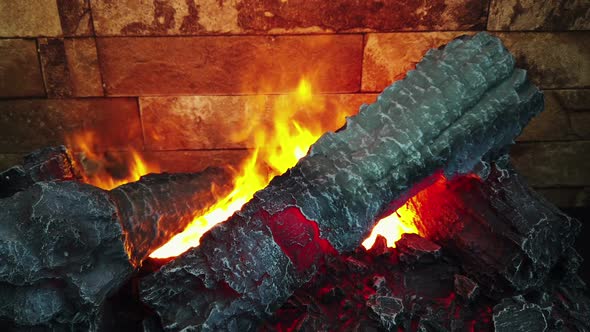 an Artificial Fire Burns in the Fireplace with Wood
