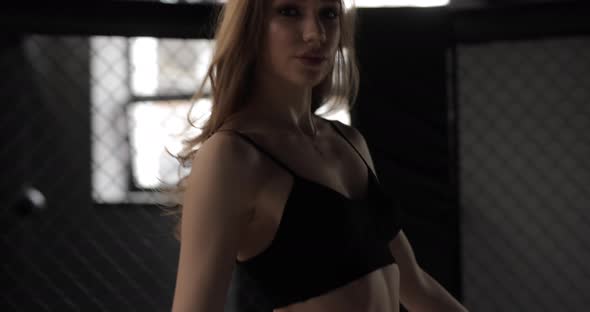 Sexy Boxer Woman in the Boxing Gloves on MMA Ring