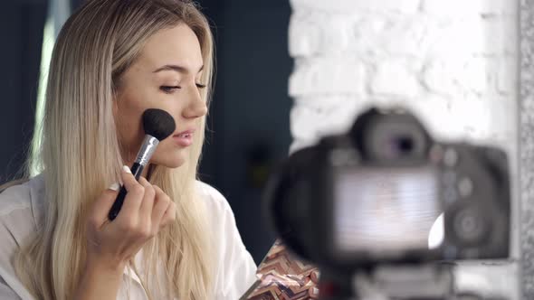 European Blond Beautiful Makeup Artist Is Doing Contouring alt
