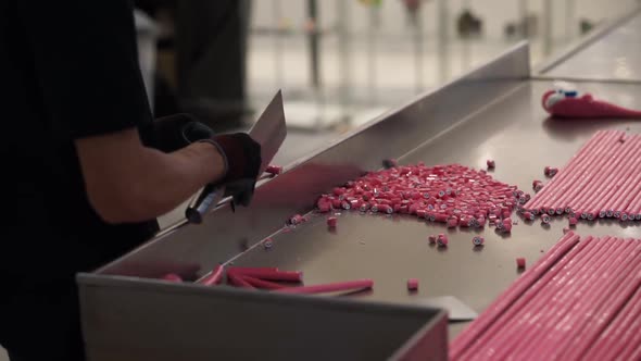 A man cutes candy with the speed and precision of a robot.