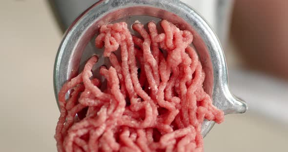 Cooking Raw Minced Meat at Home on a Meat Grinder.  alt
