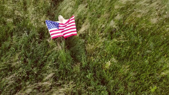 American Woman Proudly Holding American Flag at Sunset Field Celebrate 4Th of July alt
