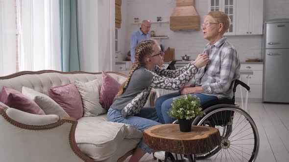 Caring Granddaughter Buttoning Blouse on Grandma alt