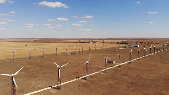 Small Wind Turbines with Blades in the Field Aerial View alt