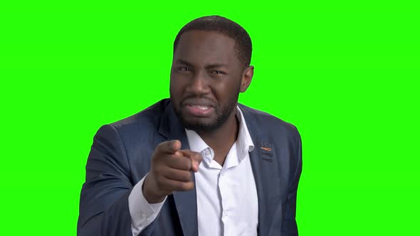 Annoyed Afro-american Businessman on Green Screen. alt