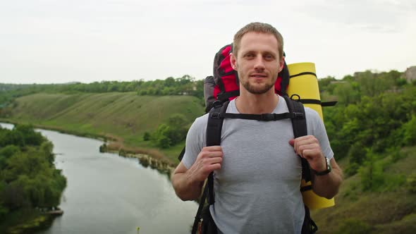 Happy Young Man in the Mountains He Rejoices Standing Against the Backdrop of a Beautiful Landscape