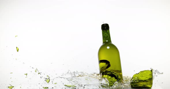 900135 Bottle of White Wine Breaking and Splashing against White Background, Slow motion 4K alt
