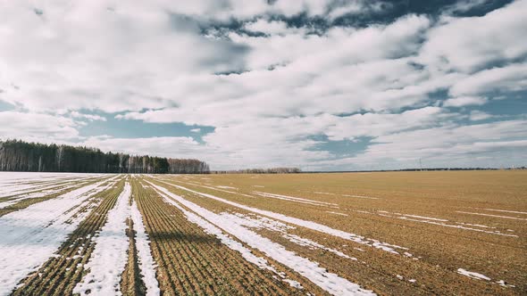 Spring Plowed Field Partly Covered Winter Melting Snow Ready For New Season alt