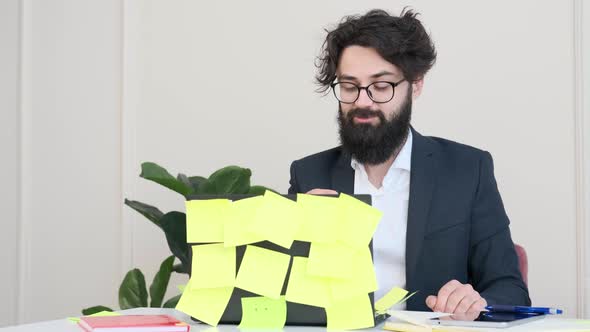 Bearded Man Comfortable at His Desk in Underwear and Jacket Working Remote alt
