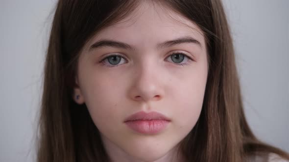 Portrait of a Small Young Sad Girl with Big Blue Eyes alt