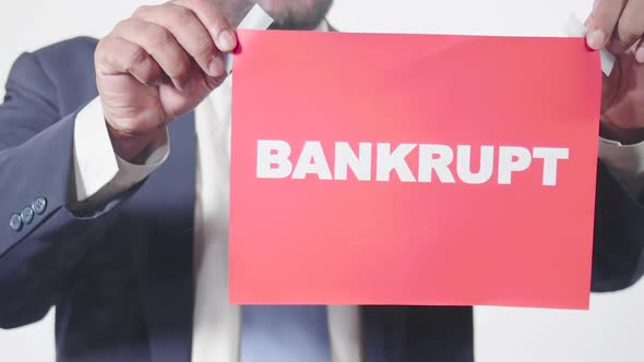 Businessman Posts Sign On Window Bankrupt alt