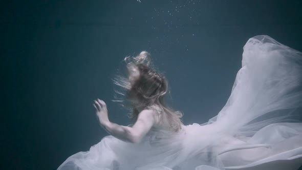 Woman in a White Dress in Deep Blue Ocean