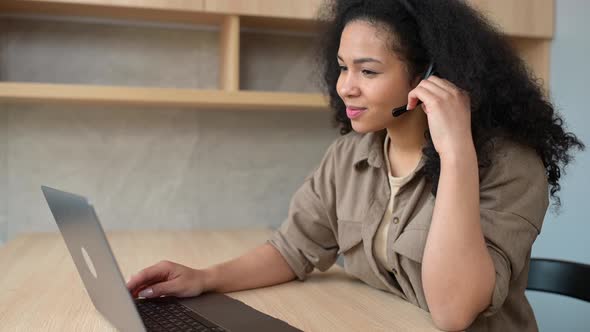 Smiling Young Multiracial Woman Wearing Headset with Mic Talking Online