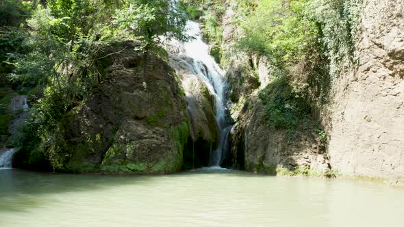 Slow Zoom in Shot of Beautiful Waterfalls in the Mountains alt