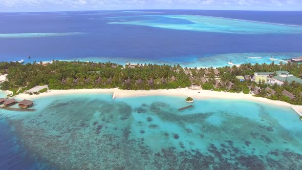 Aerial view of transparent water with coral near Maldives island. alt