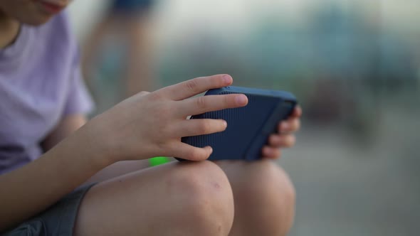 The Student's Hands are Holding a Phone