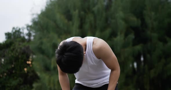 Man in earphone running and break alt