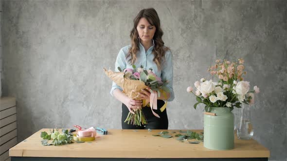 Portrait of Happy Female Florist with Bouquet Roses and Peone Looking at Camera alt