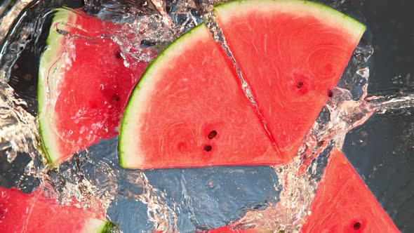 Super Slow Motion Shot of Splashing Fresh Melon Cuts Into Water at 1000 Fps alt