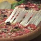 A pizza lifter takes out a slice from a pizza that has various of toppings - VideoHive Item for Sale